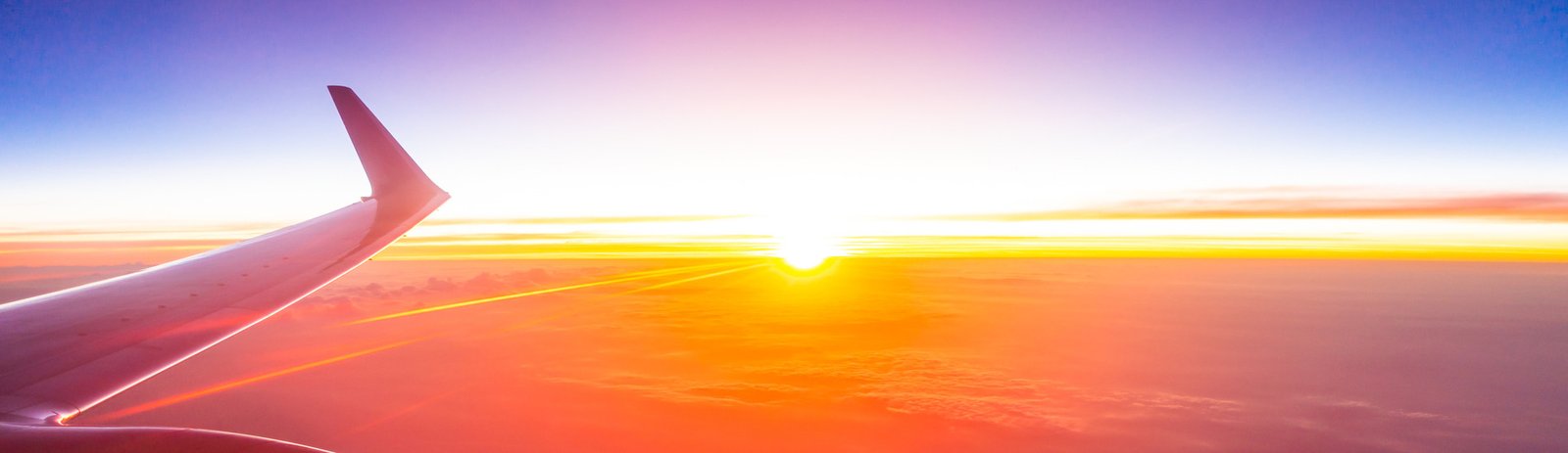 Sunrise over the clouds from a cabin window