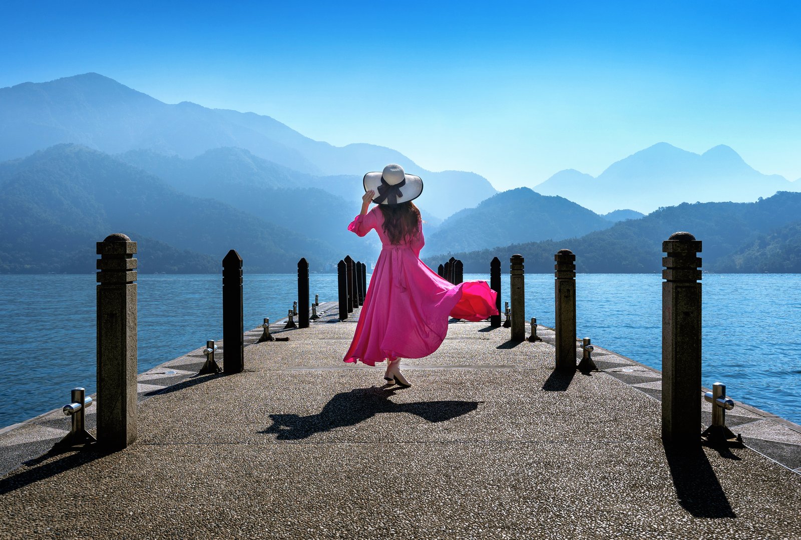 Traveller on a lakeside pier